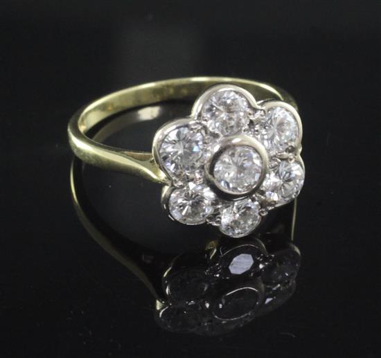 A modern 18ct gold and seven stone diamond cluster flower head ring, size P.